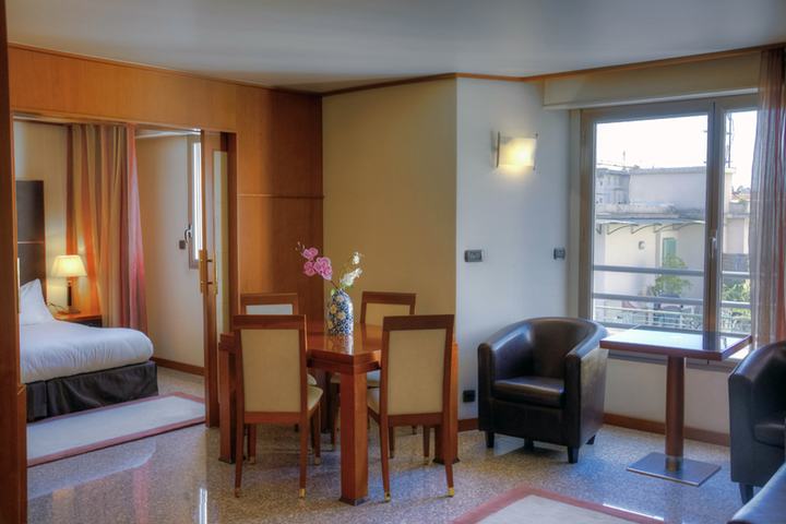 Dining area of an apartment under bulb light, untreated.