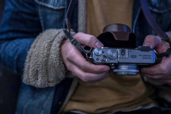 Hands holding a photo camera.